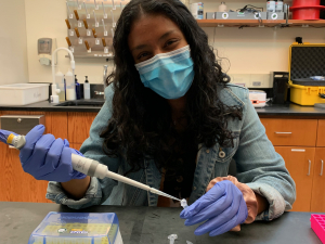 Brinda using a pipette in the lab