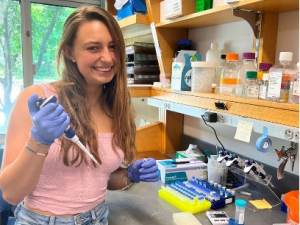 Julia Caci holding a pipette at a wet lab bench