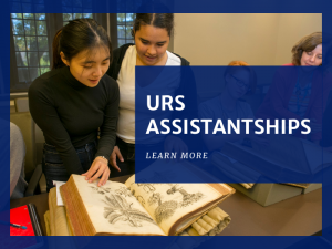 Graphic Reads: URS Assistantships. There are 2 girls looking at a book. 