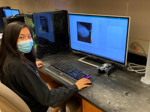 Grace working at a desktop in the lab