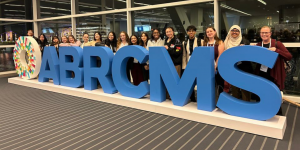 2024 DiSTEM awardees behind the ABRCMS sign